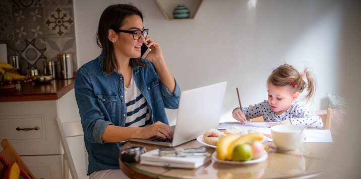 photo of a parent on the phone with a child nearby