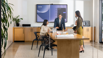 Four office workers collaborating on Surface